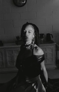 a black and white photo of a woman sitting in a room